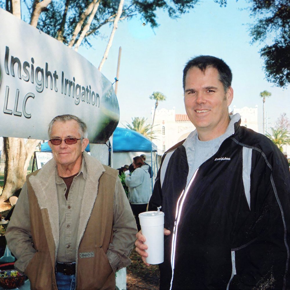 Ron Smith and his son Aaron Smith at an early Insight Irrigation trade show booth, company banner overhead