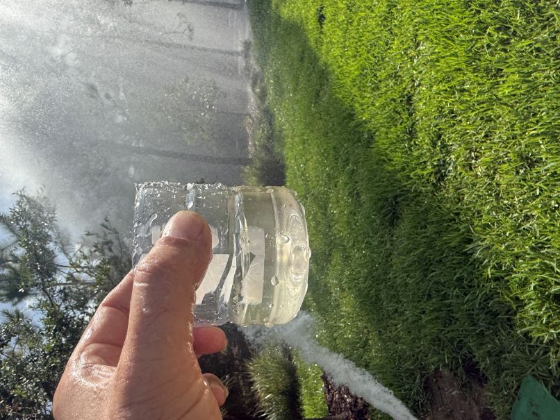 A clear water sample taken after the mainline flush process is complete.